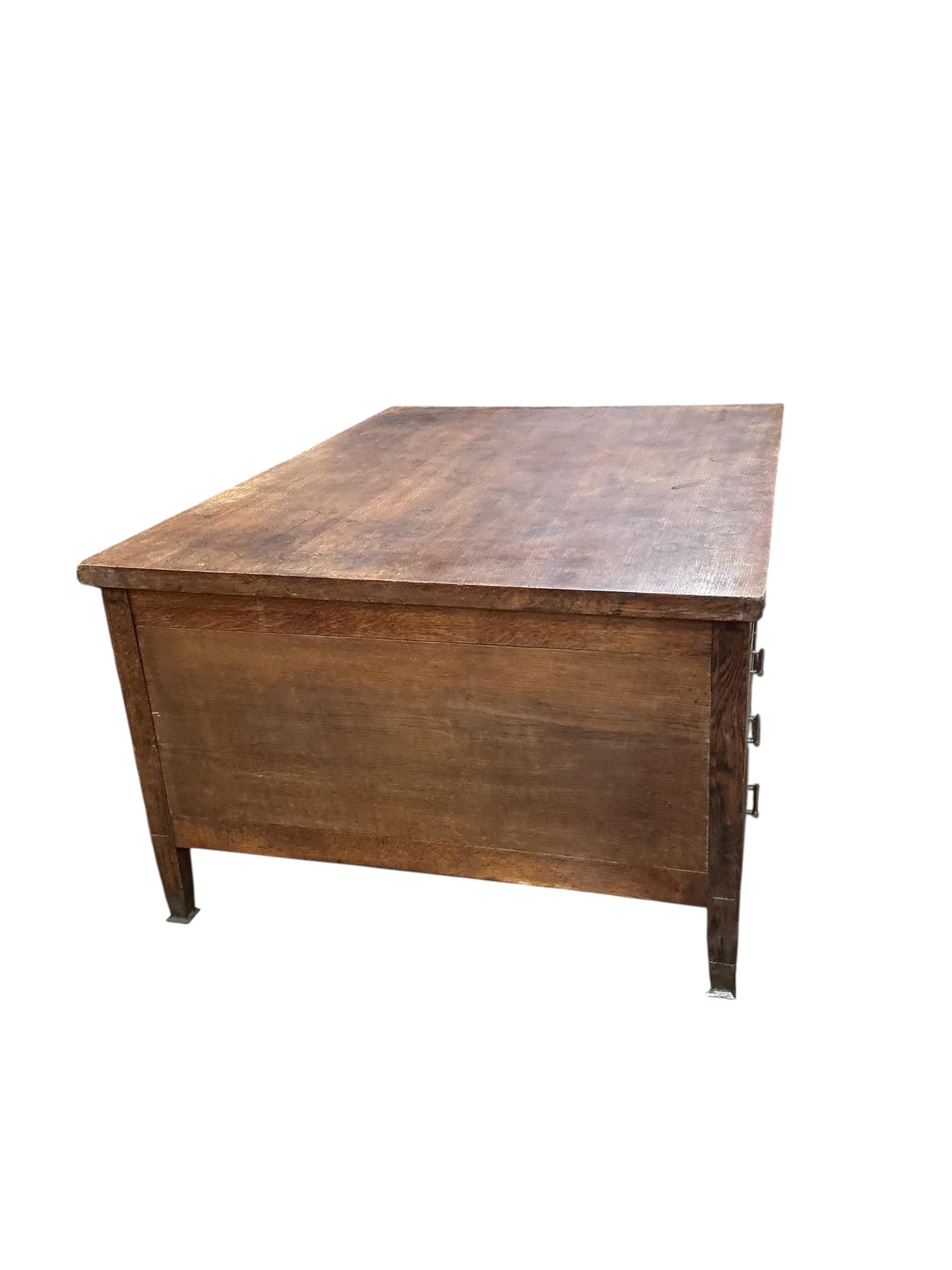 An early 20th century Continental oak kneehole partner's desk, width 168cm, depth 122cm, height 79cm